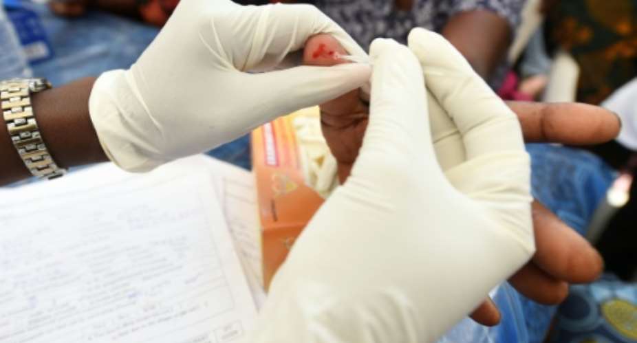A health official tests for malaria, a disease that killed more than 400,000 people worldwide in 2015, with most of the deaths occurring in sub-Saharan Africa.  By Pius Utomi Ekpei AFPFile
