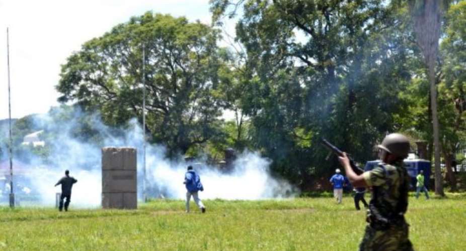 Police fire tear gas at a demonstration in Blantyre on March 11, 2013.  By  AFP