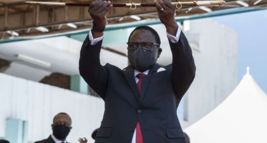 Malawi's new President Lazarus Chakwera shows the sword of office.  By AMOS GUMULIRA AFP