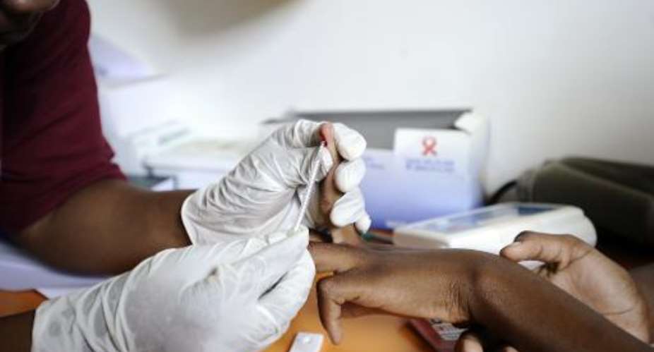 File photo of a nurse taking a blood sample in a mobile clinic set up to test students for HIV at a school near Mtubatuba in Kwazulu Natal, South Africa.  By Stephane de Sakutin AFPFile