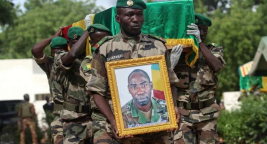 Malian army officers carry the coffin of a soldier killed during an attack on a military base in Nampala claimed by the Ansar Dine jihadist group and another armed ethnic group.  By Anthony Fouchard AFPFile