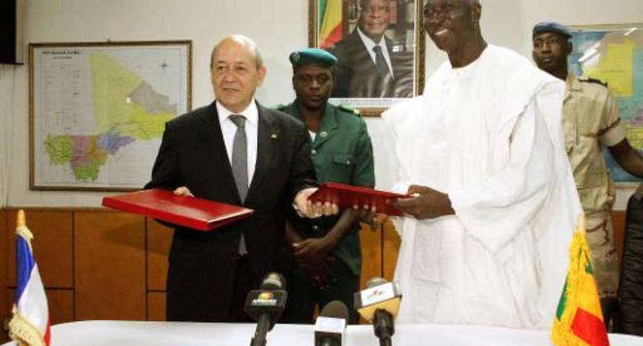 French Defense Minister Jean-Yves Le Drian L and his Malian counterpart Bah N'Daw pose on July 16, 2014 in Bamako.  By Habibou Kouyate AFP