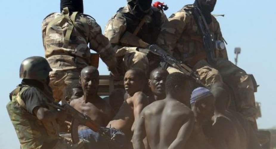 Malian soldiers transport a dozen suspected Islamist rebels after arresting them north of Gao on February 8, 2013.  By Pascal Guyot AFP