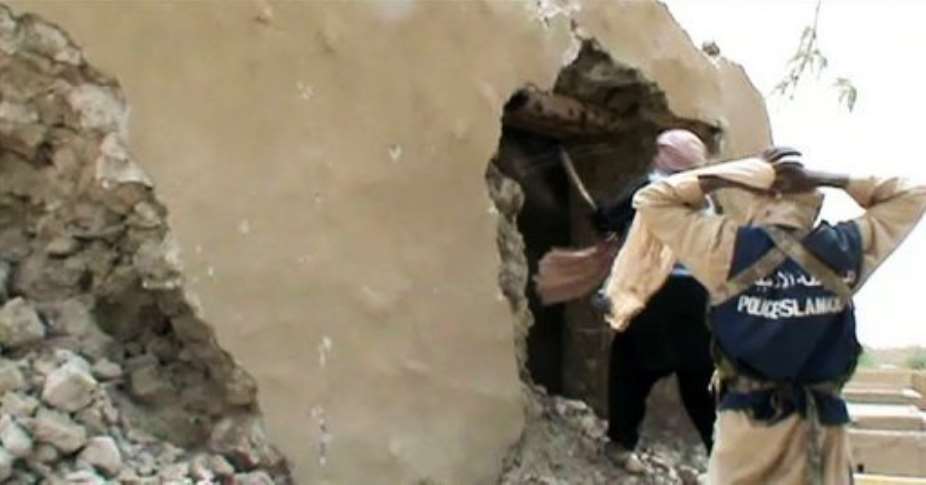 A still from a video shows Islamist militants destroying an ancient shrine in Timbuktu on July 1.  By  AFP