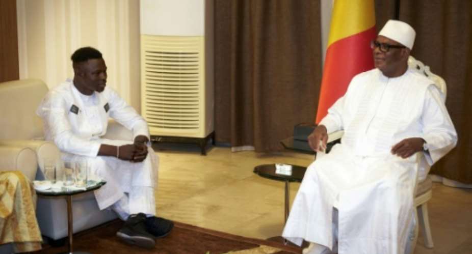 Mali President Ibrahim Boubacar Keita right says he is very proud of Mamoudou Gassama, the young Spiderman migrant who saved a child hanging from a balcony in central Paris by scaling the building with his bare hands.  By Michele CATTANI AFP