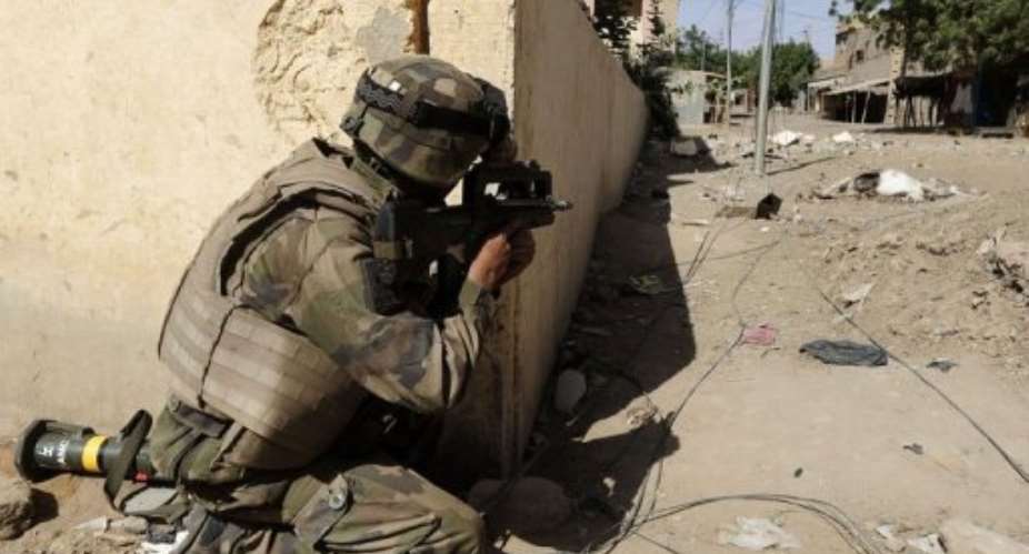 A French sniper holds position as soldiers patrol next to the central police station, on February 11, 2013 in Gao, Mali.  By Pascal Guyot (AFP/File)