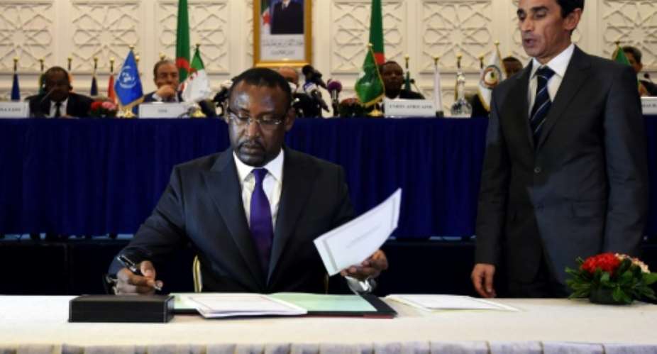 Malian Foreign Minister Abdoulaye Diop C is seen signing a peace agreement in 2015, as part of mediation talks between the Malian government and some northern armed groups in the Algerian capital Algiers.  By FAROUK BATICHE AFPFile