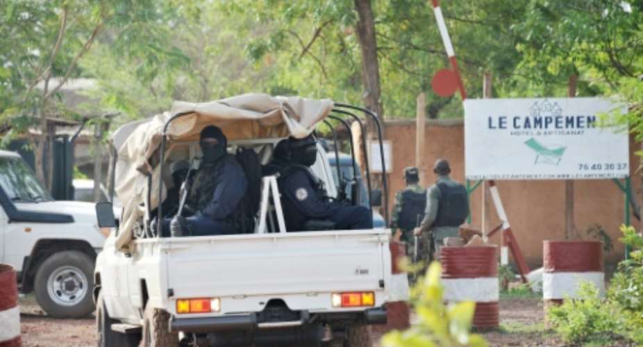 Malian police enter the Kangaba tourist resort just east of the capital Bamako a day after the assault which began on Sunday.  By Habibou KOUYATE AFP