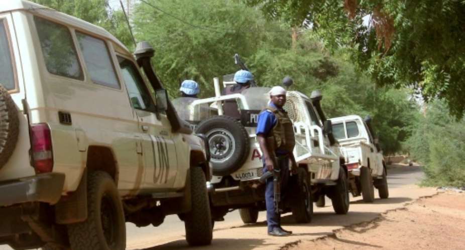 Malian police patrol with German UN mission in Mali MINUSMA peacekeping forces on May 18, 2016 in Gao, northern Mali.  By SOULEYMANE  AG ANARA AFPFile