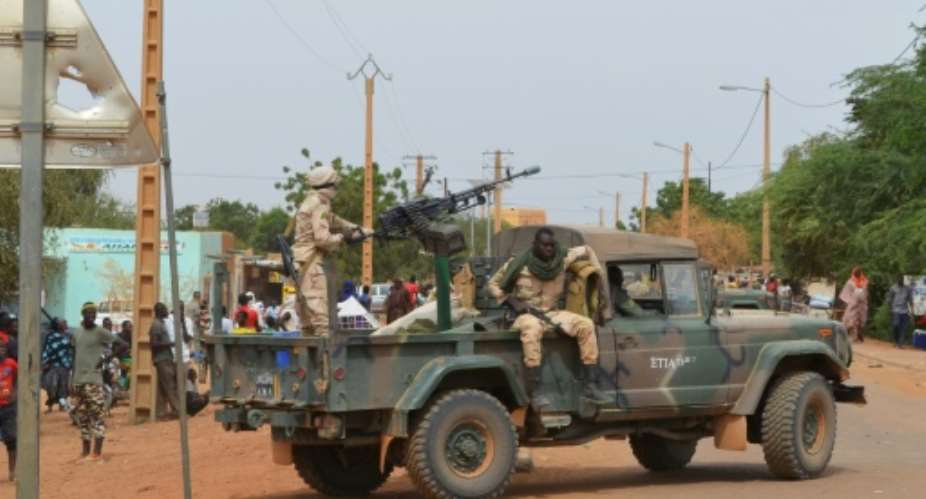 Malian soldiers on patrol in the city of Gao after a deadly suicide car bomb detonated in November 2018.  By STR AFPFile