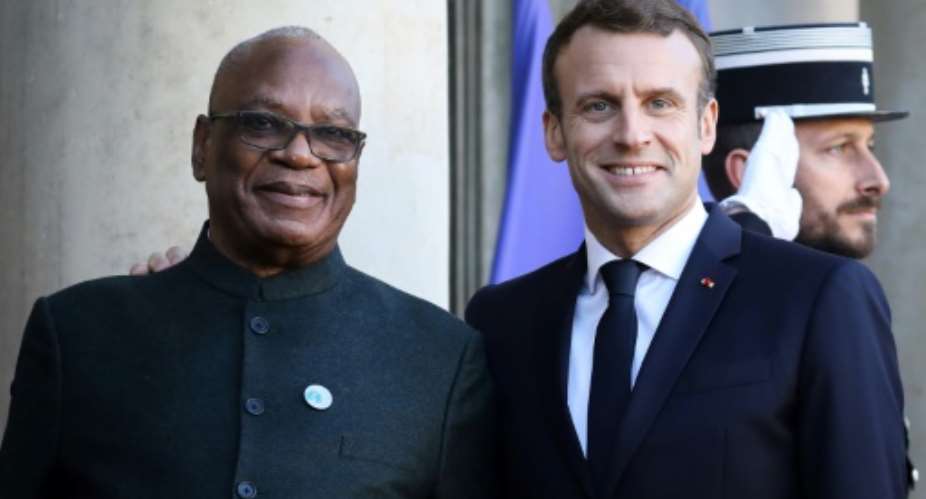 Mali's leader Ibrahim Boubacar Keita, seen here with French President Emmanuel Macron, has urged Malians against hostility to foreign forces in the country.  By LUDOVIC MARIN AFP