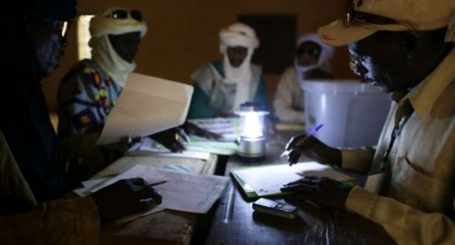Malian electoral agents count the votes at a polling station in Kidal, northern Mali, on July 28, 2013.  By Kenzo Tribouillard (AFP)