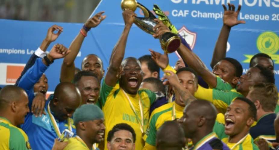 Mamelodi Sundowns players celebrate with the 2016 CAF Champions League trophy at the Borg el-Arab Stadium near Alexandria, Egypt on October 23, 2016.  By STRINGER AFPFile