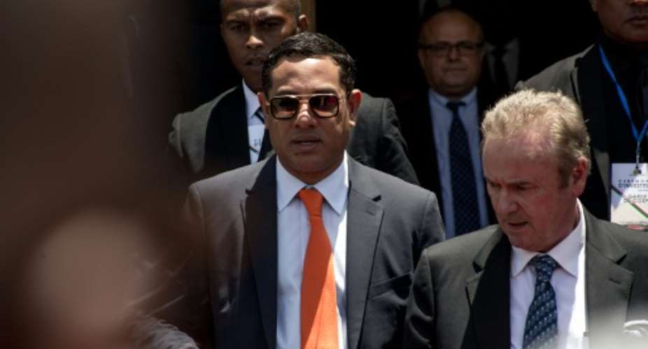 Mamy Ravatomanga (centre) is detained in Mauritius and faces money laundering accusations.  By RIJASOLO (AFP/File)