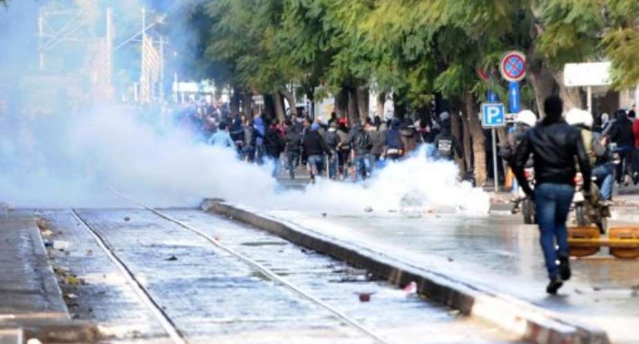 Police fire tear gas to disperse protesters on Habib Bourguiba Avenue in Tunis on February 8, 2013.  By Salah Habibi AFPFile