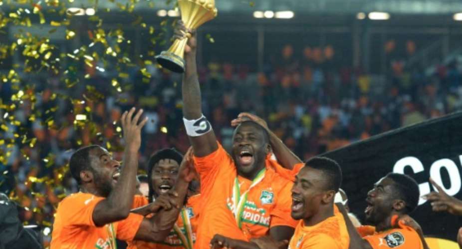 Ivory Coast's midfielder Yaya Toure C raises the trophy at the end of the 2015 African Cup of Nations final football match between Ivory Coast and Ghana in Bata on February 8, 2015.  By Khaled Desouki AFPFile