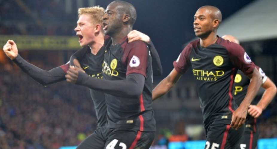 Manchester City's Yaya Toure C celebrates with Kevin De Bruyne L and Fernandinho R after scoring his second goal against Crystal Palace on November 19, 2016.  By Olly Greenwood AFP