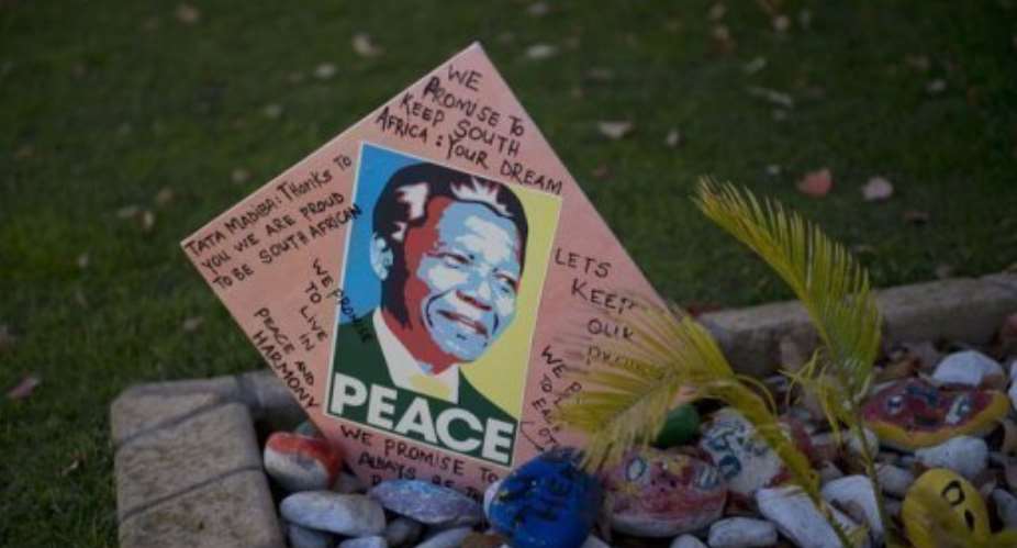 Messages for Nelson Mandela are pictured outside of his Johannesburg home on June 9, 2013.  By Alexander Joe AFPFile