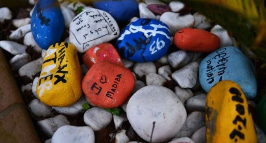 painted stones left by well-wishers are pictured outside Nelson Mandela's residence in Johnnesburg on April 3, 2013.  By Carl de Souza AFPFile