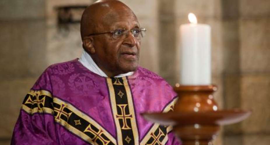 Archbishop Emeritus Desmond Tutu leads a service in St. George's Cathedral on December 6, 2013, after the anouncement of the death of Nelson Mandela, in Cape Town.  By Rodger Bosch AFPFile