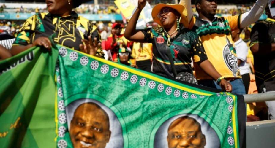 Many ANC supporters came to the final rally before next weeks general election with portraits of President Cyril Ramaphosa.  By Phill Magakoe (AFP)