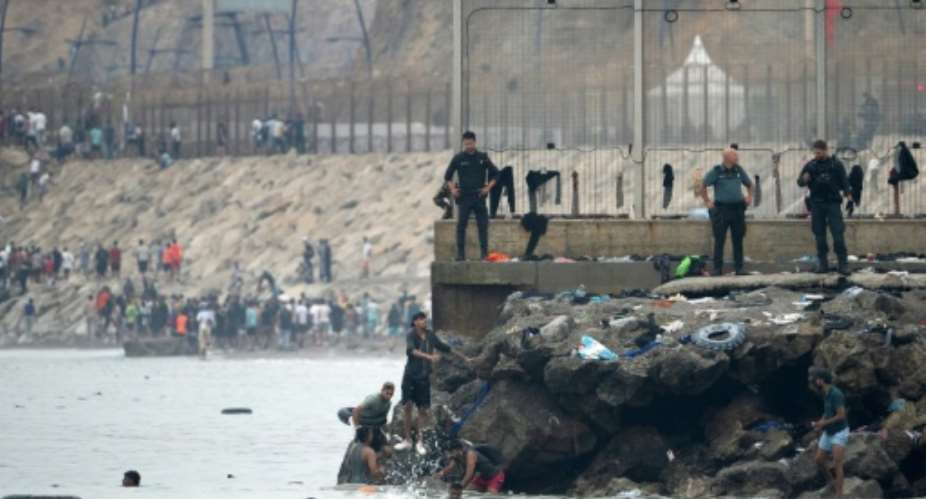 Many of the migrants have been swimming around a border barrier to get to Cueta.  By JORGE GUERRERO (AFP)