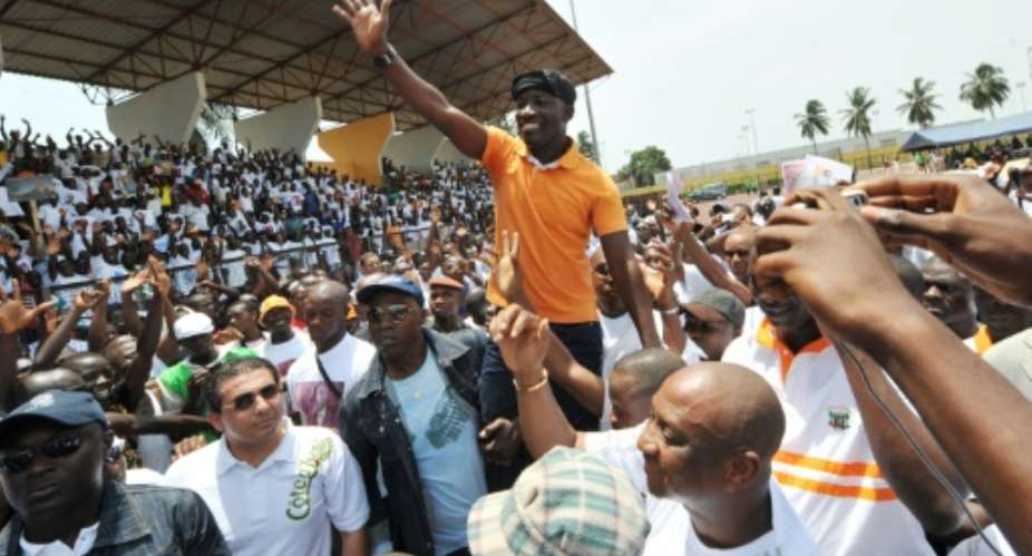 March 2010: Ble Goude, then head of President Gbagbo's youth wing, waves at a campaign rally.  By SIA KAMBOU AFP