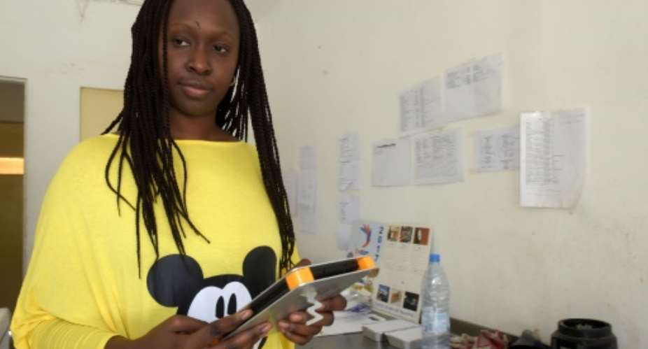 Marieme Assietou Diagne, who manages a health food delivery business, says she has gained more free time and better sales since using the Weebi app.  By SEYLLOU AFP