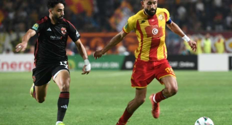 Marwan Attia (L) of Al Ahly challenges Ghaylene Chaalali of Esperance during the first leg of the 2024 CAF Champions League final in Tunisia..  By Fethi Belaid (AFP)