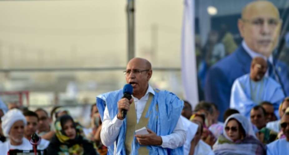 Mauritania's President Mohamed Ould Cheikh El Ghazouani, C seen here on the campaign trail, was sworn in after winning a June election.  By SIA KAMBOU AFP