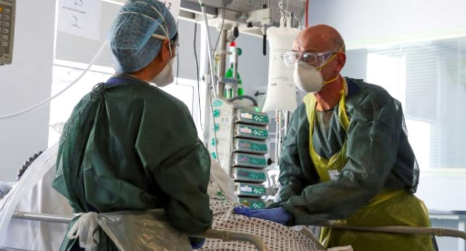 Medical staff in intensive care routinely wear full protective equipment.  By Steve Parsons POOLAFPFile