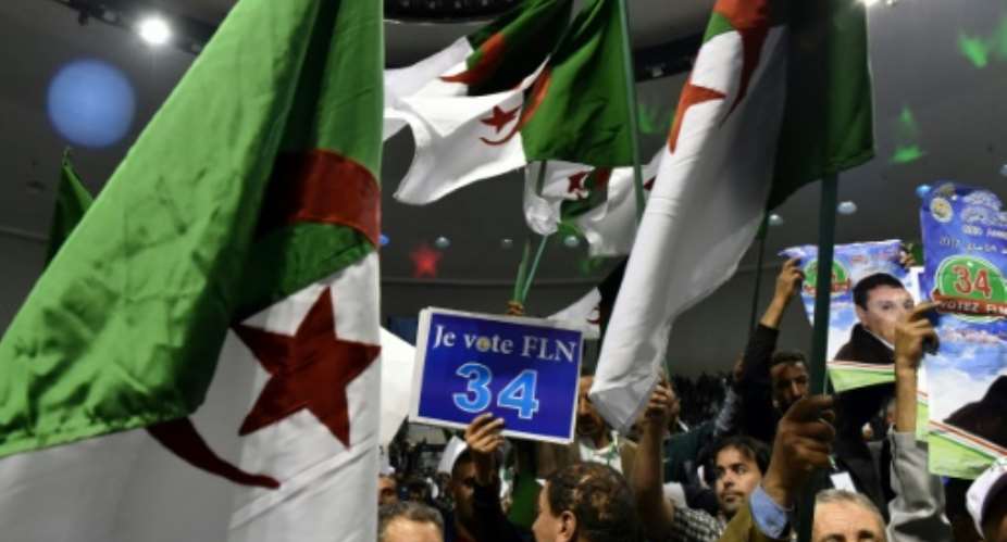 Members of Algerias National Liberation Front (FLN) gather at a party conference in Algiers on April 28, 2017, while campaigning for May 4 elections. Media reports suggest however that Algerians are more interested in the French presidential election.  By RYAD KRAMDI (AFP/File)