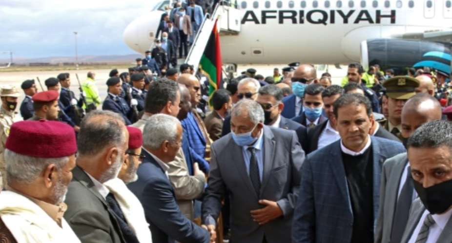 Members of an official delegation from Libya's Government of National Unity arrive in the eastern Libyan city of Benghazi on March 23, 2021, for the eastern administration's handover of power.  By - AFP