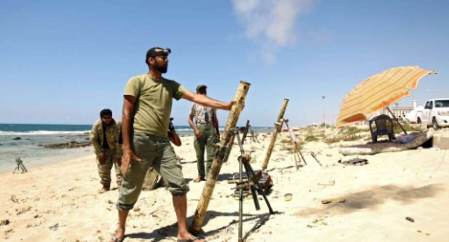 Members of forces loyal to Libyan military strongman Khalifa Haftar fire mortar shells during clashes with militants in Benghazi on July 19, 2017.  By Abdullah DOMA AFPFile