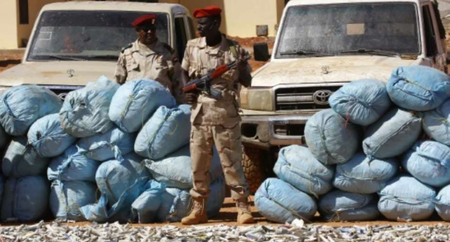Members of Rapid Support Forces RSF, Sudans controversial counter-insurgency unit, show on November 5, 2017 in Khartoum sacks of hashish that were captured in the state of South Darfur a week earlier.  By ASHRAF SHAZLY AFP