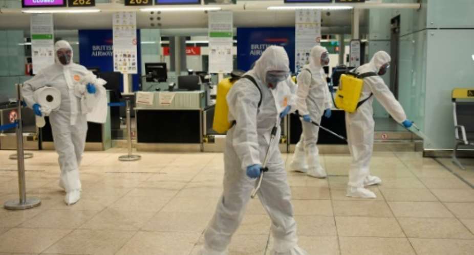 Members of Spain's Military Emergencies Unit UME carry out a disinfection at Josep Tarradellas Barcelona-El Prat airport.  By Josep LAGO AFP