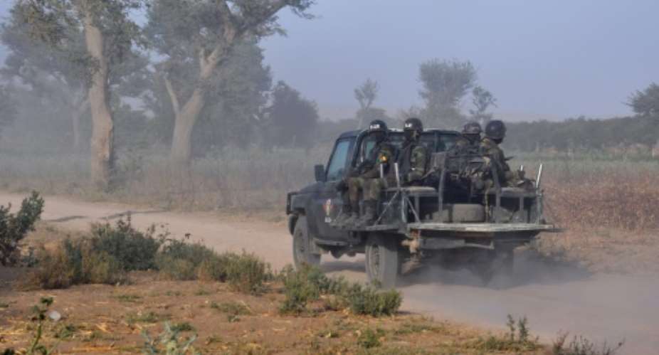 Members of the Cameroonian Rapid Intervention Force patrol on the outskirt of Mosogo in the far north region of the country where Boko Haram jihadists have been active since 2013, on March 21, 2019.  By Reinnier KAZE AFPFile