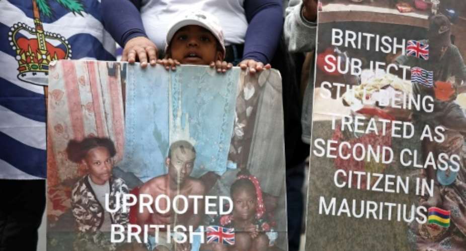 Members of the Chagossian community and supporters protested outside the High Court as a hearing into the fate of the Chagos Islands, went on inside.  By HENRY NICHOLLS (AFP)