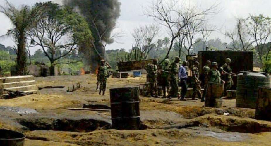 Members of the Joint Military Task Force search illegal oil refineries at Mbiama community in Nigeria's Bayelsa State on March 6, 2011.  By STR AFPFile