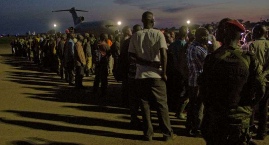 Members of the M23 rebel group waiting at a Ugandan army air base to be flown to the Democratic Republic of Congo in 2014.  By ISAAC KASAMANI AFPFile