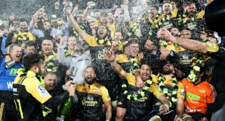 Members of the Wellington Hurricanes celebrate their victory after the Super Rugby Final match against the Lions of South Africa, at Westpac Stadium in Wellington, in August 2016.  By Martin Hunter AFPFile