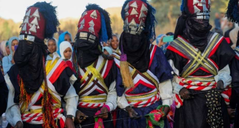 Men perform a traditional dance during the Sebeiba Festival, a yearly celebration of Tuareg culture, in the oasis town of Djanet in southeastern Algeria, on July 29, 2023.  By - (AFP)