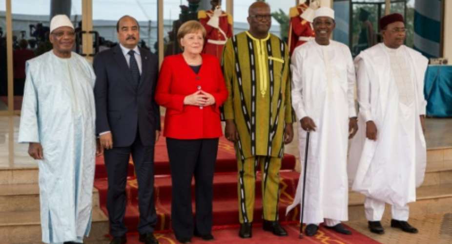 Merkel attended a G5 meeting of Sahel country leaders in Ouagadougou.  By OLYMPIA DE MAISMONT AFP