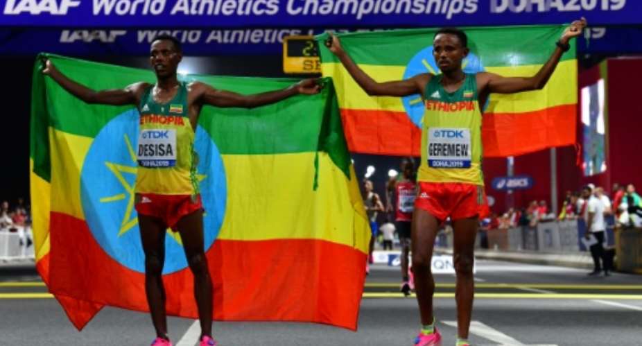 Migrant workers turned out in force to support runners from their native countries at the World Athletics Championships men's marathon in Doha, which saw Ethiopia's Lelisa Desisa L win gold.  By Giuseppe CACACE AFP