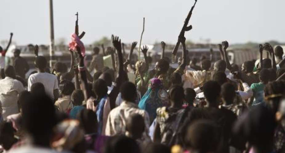 Sudan People's Liberation Army SPLA soldiers wave their weapons as tehy celebrate alongside displaced people in Malakal after recapturing the town from rebels on March 19, 2014.  By Ivan Lieman AFPFile