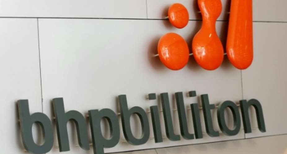 BHP Billiton's South32 spin-off said the dire outlook for commodity prices after recent plunges meant it expected to book 1.7 billion in pre-tax, non-cash charges.  By William West AFPFile