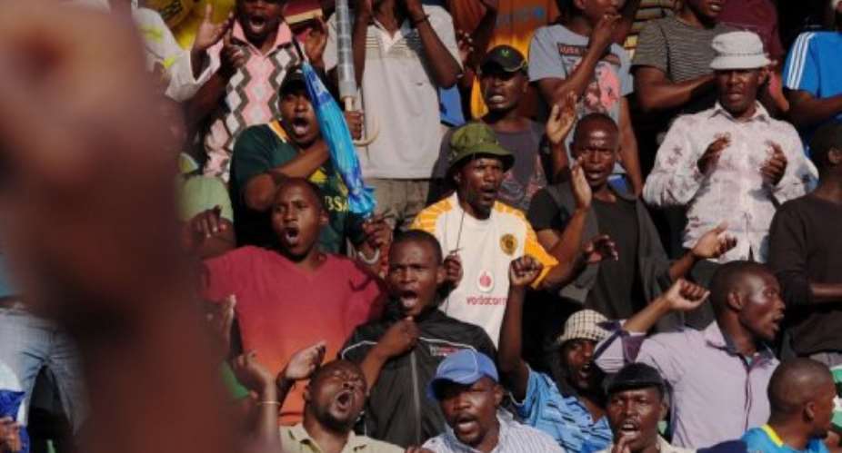 Striking miners celebrate having secured a pay hike from London-listed Lonmin platinum mine in Marikana on September 18.  By Alexander Joe (AFP/File)