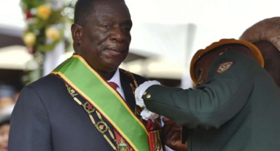 Mnangagwa took the oath of office at the national sports stadium before thousands of cheering supporters, dignitaries and foreign diplomats..  By TONY KARUMBA AFP