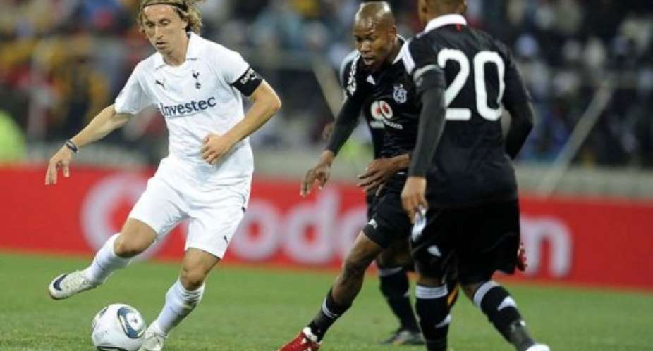 Tottenham Hotspurs Luka Modric (L) vies with Orlando Pirates Happy Jele.  By Frennie Shivambu (AFP)