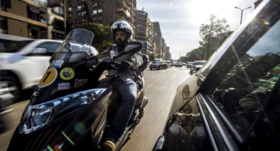 Mohamed Abdel-Wahed is one of many Cairo residents turning to motorbikes to navigate the city's heavy traffic jams.  By KHALED DESOUKI AFP